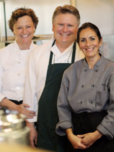 Marcella, David and Luz in the kitchen at Woodruff's