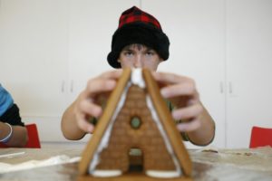 Elias Fotou, 13, of Petaluma makes a gingerbread house at the Gingerbread Doghouse Workshop at the Charles M. Schulz Museum in Santa Rosa, California. (photo by Ramin Rahimian, 2011)