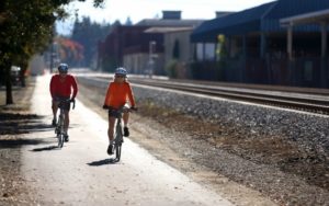 John and Pat Rich ride along the multi-use trail next to the SMART tracks, between 8th Street and College Avenue in Santa Rosa November 1, 2013. The trail is being extended alongside the tracks, allowing cyclists and walkers to move from Cloverdale to Larkspur. (photo by Christopher Chung)