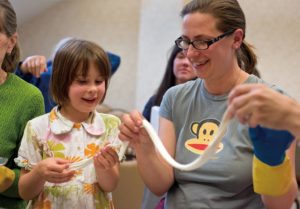 Five-year-old Dasha Kovina and her mother Anna Kovina smile as they stretch a portion of freshly made mozzarella cheese during "The Secrets of Making Stretched Curd Cheese" class at the Artisan Cheese Festival in Petaluma on March 23, 2013. (Alvin Jornada / The Press Democrat)