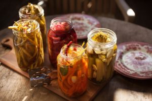 Brandon Guenther of Firefly Catering does rustic style weddings and serves meals based on a farms harvest, with fermented vegetables presented in mason jars. (Photo by Charlie Gesell)