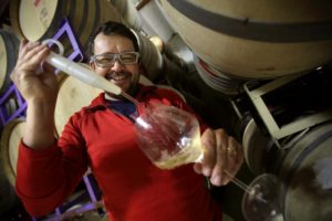 Hardy Wallace with Dirty and Rowdy Family Wines pulls a sample Punchdown Cellars in Santa Rosa on Tuesday, July 15, 2014. (Conner Jay/The Press Democrat)