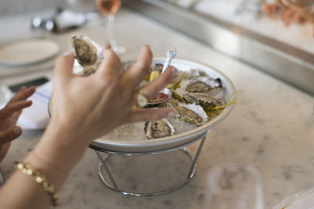 A guest tasting an assortment of oysters at Seaside Metal oyster bar in Guerneville. April 29, 2016. (Photo: Erik Castro/for The Press Democrat)