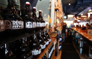 Growlers sit on a shelf behind the bar at Russian River Brewing Company in Santa Rosa. (photo by Christopher Chung)