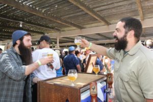Collin McDonnell of HenHouse Brewing cheers Zac Greenwood at the 18th Annual Great Chili Cook-off, Salsa & Beer Tasting that was held at the Petaluma Fair Grounds on Saturday May 9, 2015. (photo by Victoria Webb)