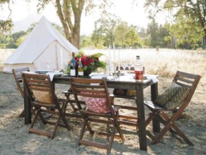A very civilized table in the wild is set to greet happy campers. (photo by Bess Friday)