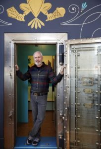 Bob Pullum, the owner of Guerneville Bank Club, stands next to the old vault inside the building. (BETH SCHLANKER/ The Press Democrat) 