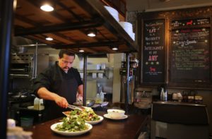 Chef Victor Escobar puts the finishing touches on a dish before sending it out to a customer at Wild Goat Bistro in Petaluma, on Wednesday, March 2, 2016. (Christopher Chung/ The Press Democrat)
