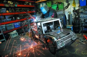 4/1/2012: T4: PC: Metal artist James Selby welds a new light bar on top of his tow truck in his Santa Rosa studio.