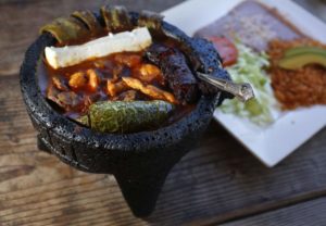 Molcajete Mixto is a hot stone bowl filed with steak, prawns, chicken, grilled cactus, queso fresco, roasted chillies, onions, tomatoes and mushrooms. (Photo by Beth Schlanker)
