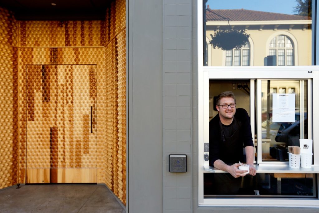 Executive chef/owner Curtis Di Fede stands inside the walk-up ice cream window beside the unique wood front door at Miminashi, a Japanese izakaya, in Napa, California on Tuesday, August 30, 2016. (Alvin Jornada