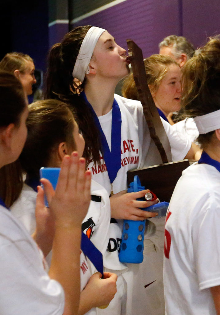 Cardinal NewmanÕs Hailey Vice-Neat, center, kisses the CIF championship trophy as the Cardinals gather in a hallway after defeating Antelope Valley with a score of 39-37 during the CIF Division IV girls basketball championship game between Cardinal Newman and Antelope Valley high schools at Sleep Train Arena in Sacramento, California, on Saturday, March 26, 2016. (Alvin Jornada / The Press Democrat)