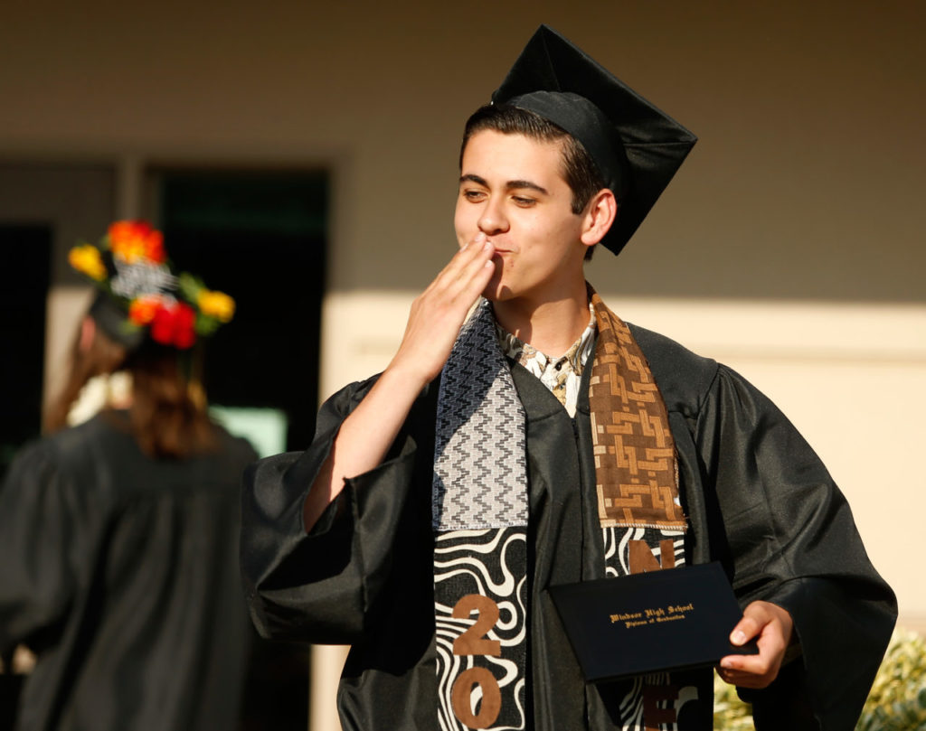 Cooper Chavez blows kisses to his friends in the audience after receiving his diploma during Windsor High School commencement exercises in Windsor, California on Saturday, May 28, 2016. (Alvin Jornada / The Press Democrat)