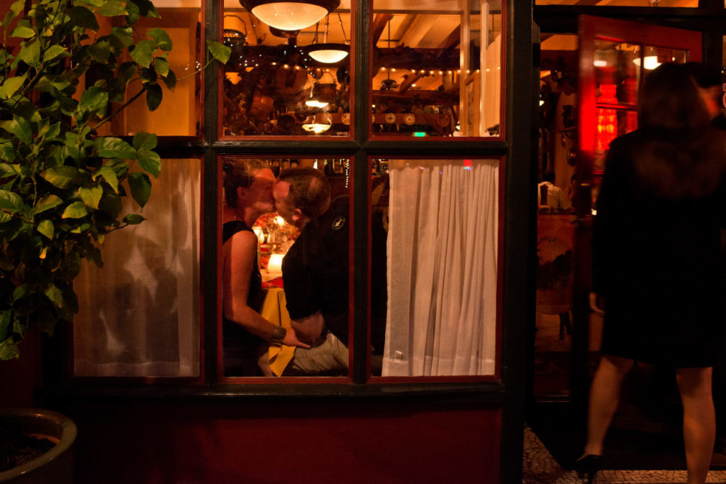 A couple kisses in the window of LoCoco's Cucina Rustica, which was voted 2013 Best Italian Restaurant for the Best of Sonoma County, in Santa Rosa, Calif., on July 10, 2013. (Alvin Jornada / For The Press Democrat)