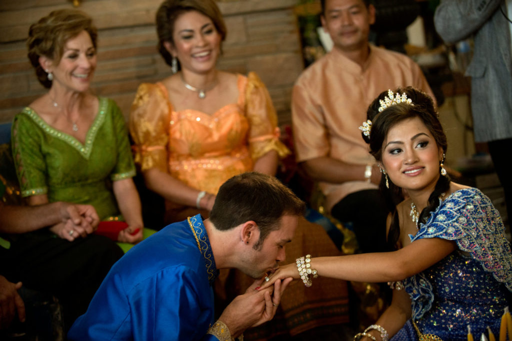 8/11/2013: T1: I DO: Michael Martini kisses the hand of his bride, Melissa, after placing the ring on her finger. PC: Michael kisses Melissa's hand after placing the ring on her finger. Melissa and Michael were married in a traditional Cambodian wedding ceremony at Martin Ray Vineyard in Santa Rosa, Calif., on July 20, 2013. (Alvin Jornada / For The Press Democrat)