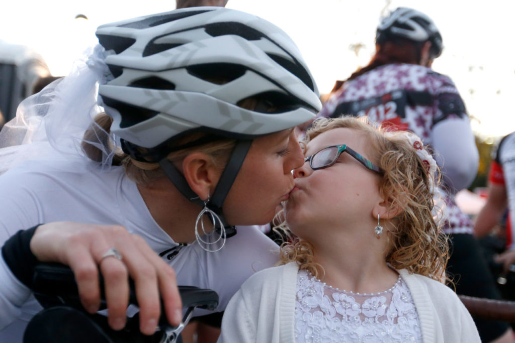 Bride-to-be Katie Excell kisses her daughter and flower girl Caitlynn Cluse, 5, before Excell gets married at Levi's GranFondo, in Santa Rosa, California on Saturday, October 1, 2016. (Alvin Jornada / The Press Democrat)