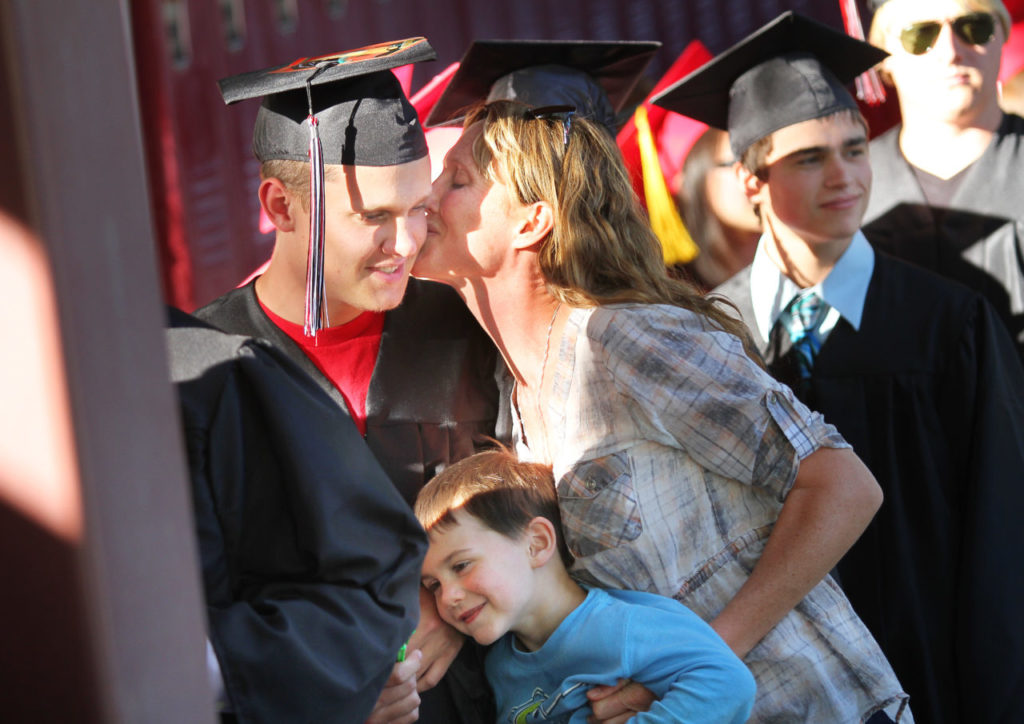 Graduating senior Skyler Hauprich receives a kiss from his mother before walking through El Molino High School's commencement ceremony on Thursday, May 30, 2013. (Conner Jay/The Press Democrat)