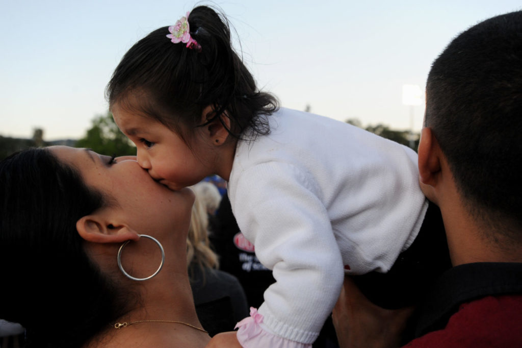 Sixteen-month-old Brittany Morales kissing her aunt Zenaida Morales during the Cloverdale High School 2010 graduation ceremony Friday evening. May 28, 2010. (Photo: Erik Castro/for The Press Democrat)