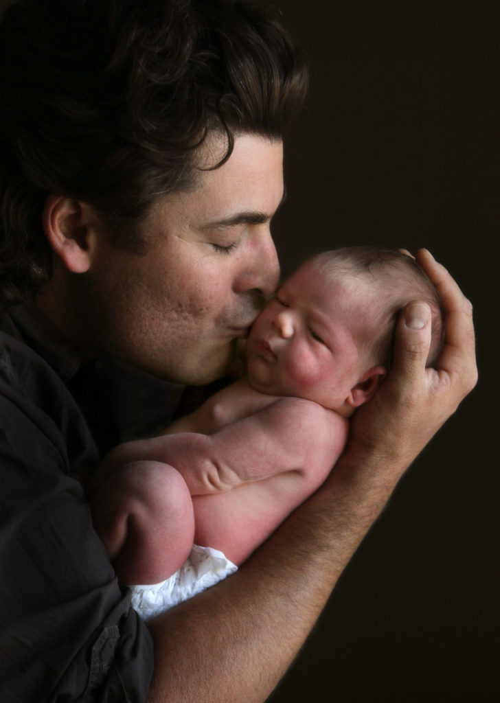6/19/2011: B1: PC: New father Miguel Soria, left, kisses his day-old daughter Raquel.