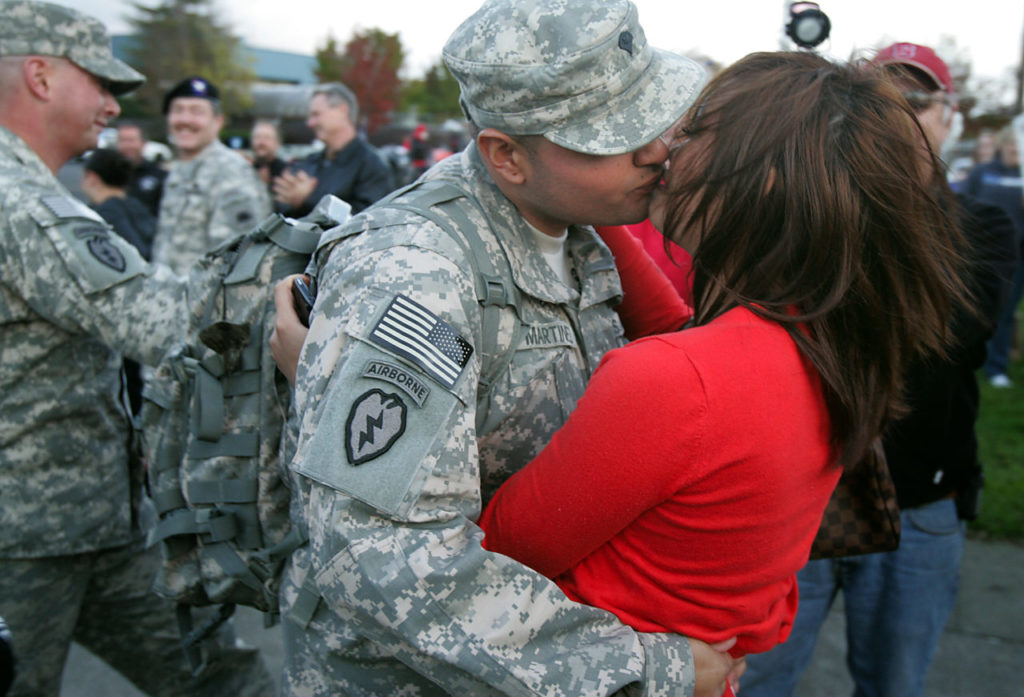 Specialist Carlos Martinez kisses his girlfriend Melanie Chhy in front of the Petaluma Armory after spending a year in Afghanistan with the California National Guard's 235th Engineer Company.