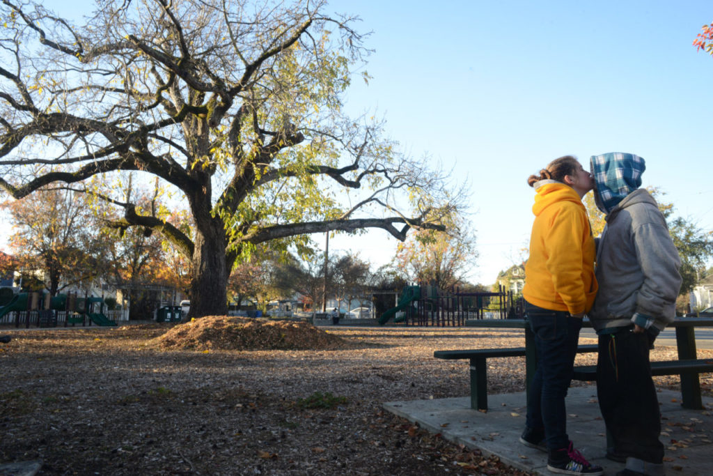 Jessie Dirks and Charlotte Warren kissing after a night under a bundle of blankets and sleeping bags on a cold Sunday morning in the mid-30s at a West End neighborhood park of Santa Rosa. December 1, 2013. (Photo: Erik Castro/for The Press Democrat)