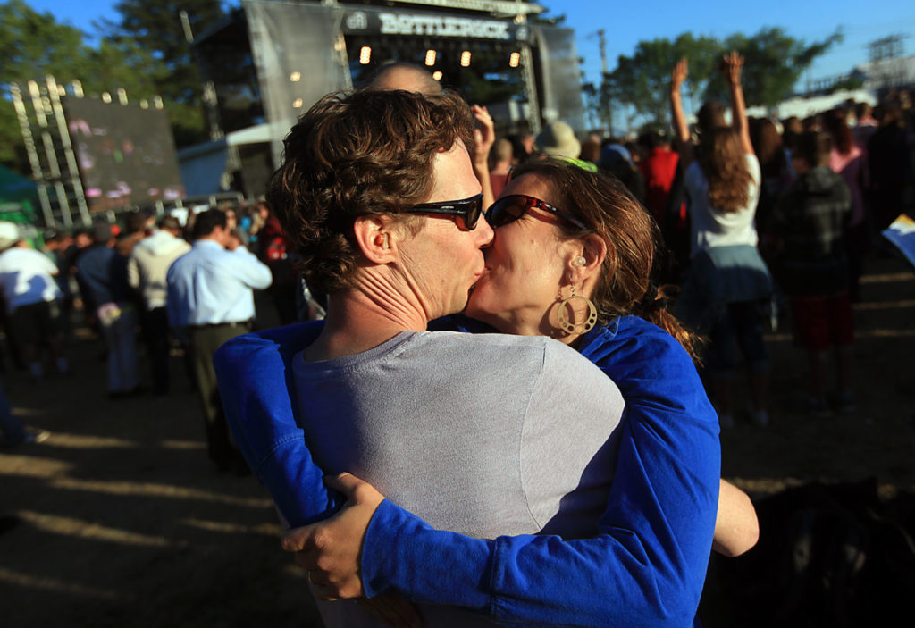 Lia Gaertner gives her boyfriend Sunjya Schweg a smooch on his 40th birthday at BottleRock in Napa, Thursday May 9, 2013. They are both from Sebastopol. (Kent Porter / Press Democrat) 2013