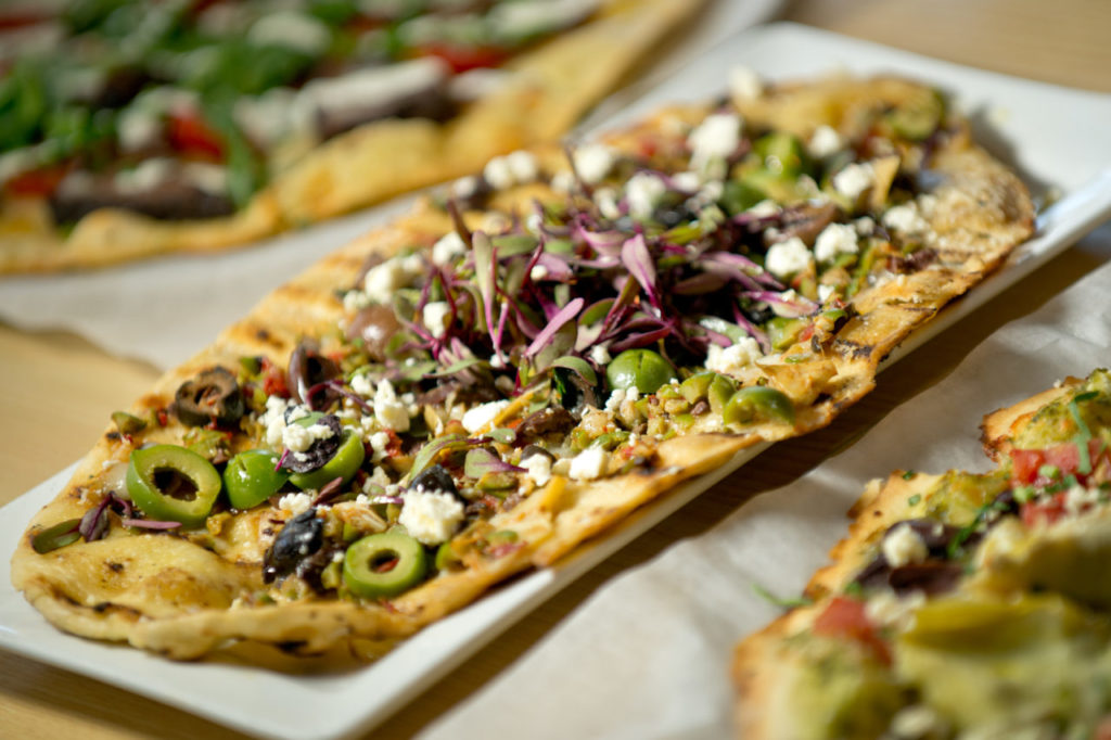 The Red Grape's Olive Flatbread, center, flanked by Braised Short Rib Pizza, left, and Mediterranean Pizza,, in Sonoma, Calif., on October 15, 2013. (Alvin Jornada / The Press Democrat)