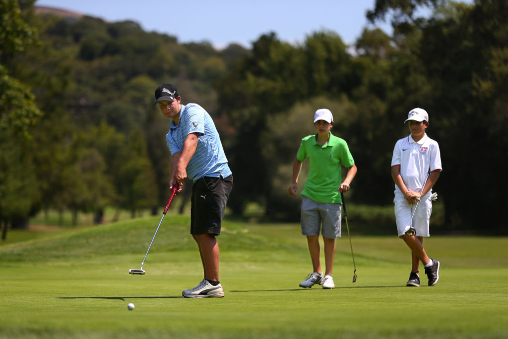 Matt Mokski, left, putts, while Michael Kelleher and Brendan Frazier watch, at the Bennett Valley Golf Club in Santa Rosa, on Wednesday, August 5, 2015. (Christopher Chung/ The Press Democrat)