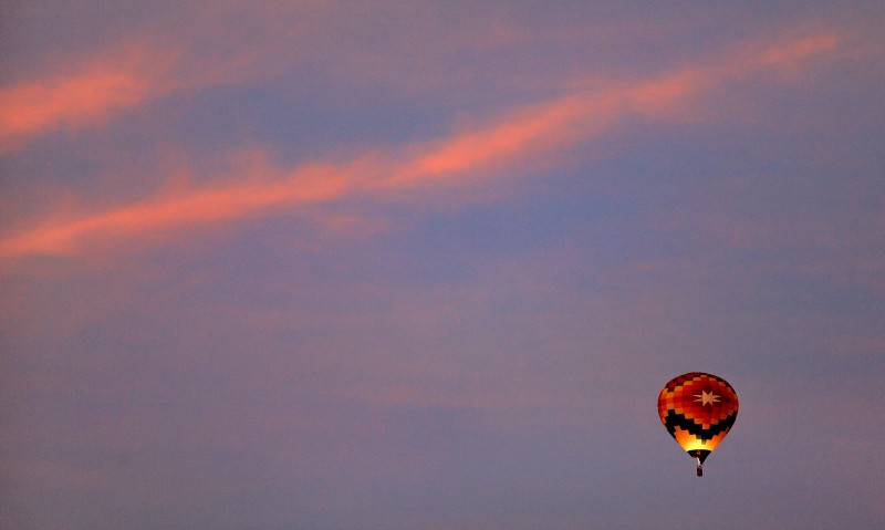 A hot air balloon ascends over Windsor at dawn. (Kent Porter/The Press Democrat)