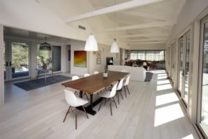 The large dining table is the heart of the great room, close to the kitchen and overlooking the front porch. Chris Hardy
