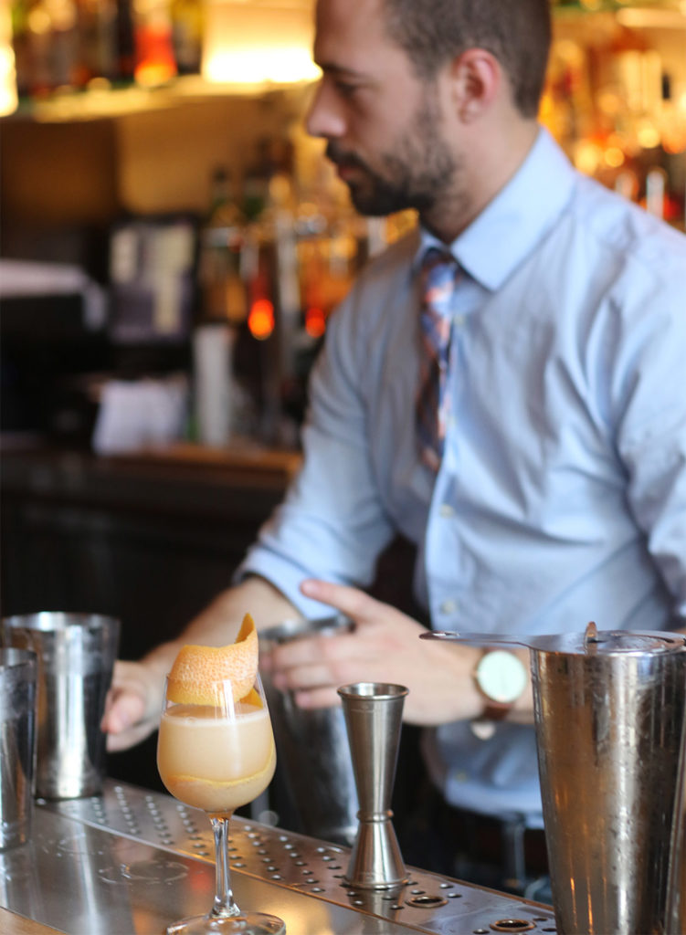 Bartender making a seasonal cocktail with grapefruit at County Bench Restaurant in Santa Rosa, Heather Irwin/PD