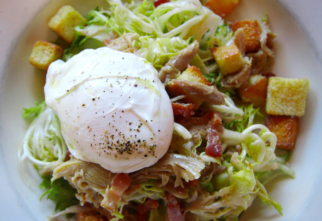 Frisee salad with lardons, duck confit and poached eggs at Bistro 29 lunch service in Santa Rosa. Heather Irwin/PD