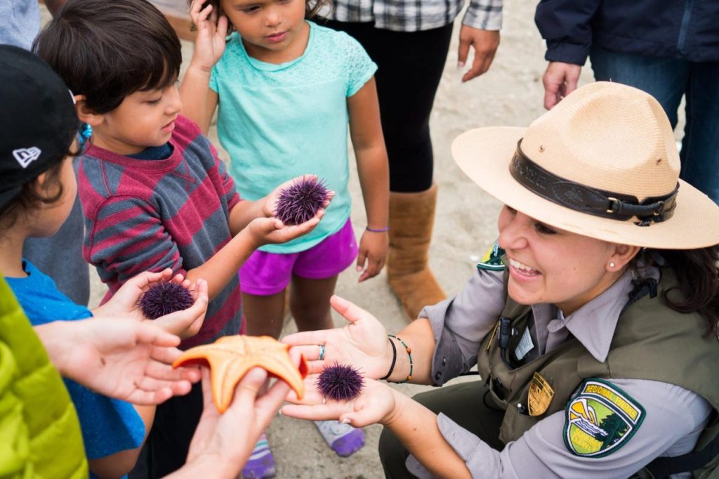 Children with a Park Ranger holding sea urchins