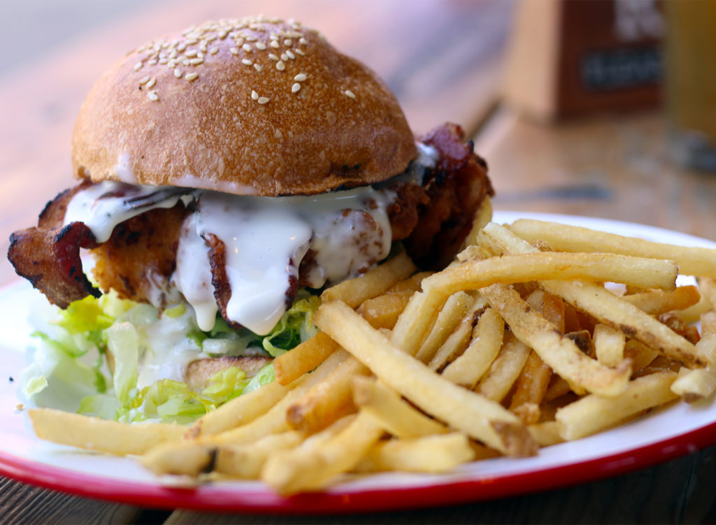 Fried chicken sandwich with goat cheddar, romaine, garlic mayo, bacon, della fattoria bun at Brewster’s Beer Garden in Petaluma. Heather Irwin/PD