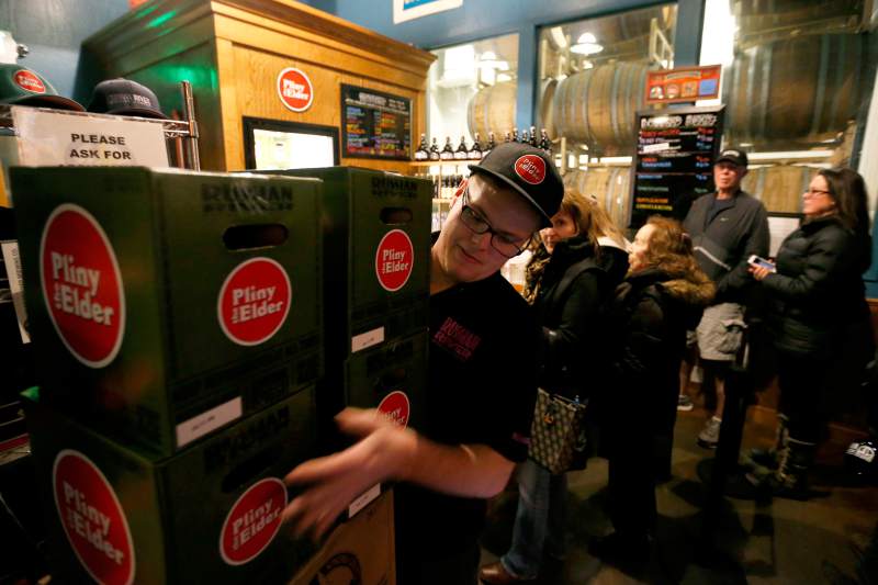 Trent William's of RRBC stacks cases of Pliny the Elder fro customers to take home at the brewpub in Santa Rosa. (Press Democrat)