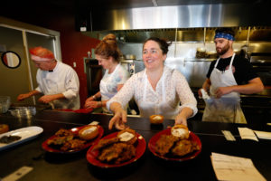 Spinster Sisters chef Liza Hinman, second from right, and her kitchen staff, from left, sous-chef David McDowell, and line cooks Kelli Bailey and Grant Mitchel prepare dishes from chef Joyce Goldstein's new cookbook The New Mediterranean Jewish Table, during a Book Passage Cooks with Books event at Spinster Sisters in Santa Rosa, California on Wednesday, June 1, 2016. (Alvin Jornada / The Press Democrat)