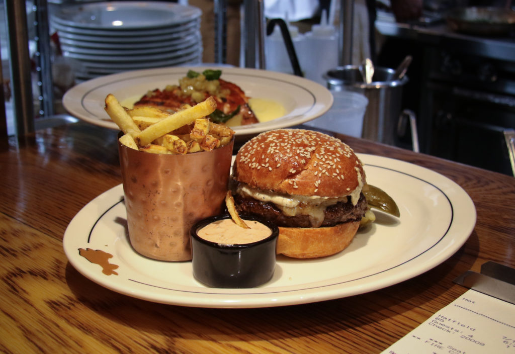Hambuger with local grass fed beef, slow cooked onion, Beecher’s cheddar, black truffle aioli, Kennebec fries at the Brass Rabbit in Healdsburg. Heather Irwin/PD