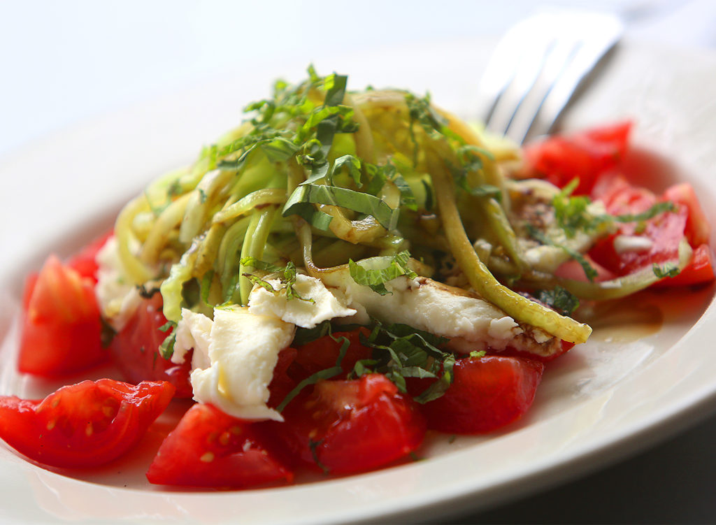 ITALY, Rosso Restaurant in Santa Rosa: Caprese salad of Parson's tomatoes, house- made mozzarella, julenne cucumber, mint, basic and balsamic vinegar.