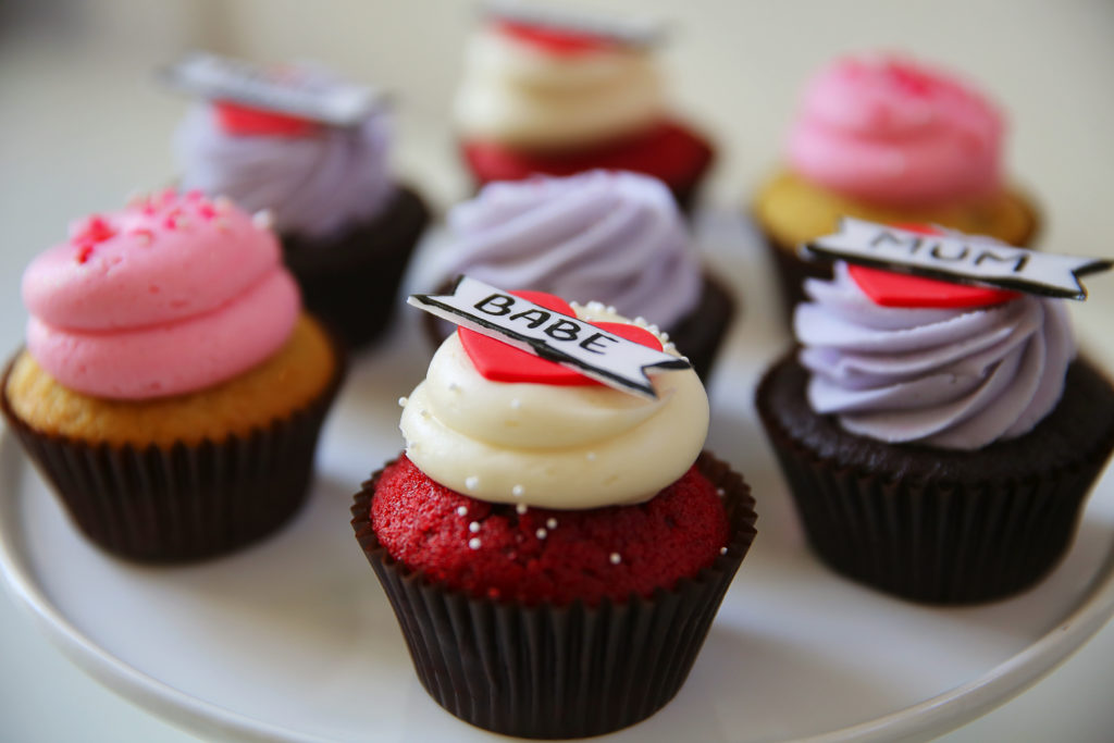 A plate of vanilla with vanilla bean, left, red velvet, and chocolate with vanilla bean cupcakes at Moustache Baked Goods, in Healdsburg. (Christopher Chung/ The Press Democrat)