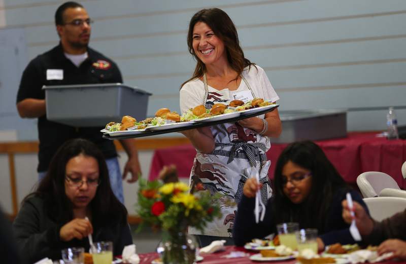 Jenny Petritz serves up Thanksgiving meals, during the Redwood Gospel Mission's annual Great Thanksgiving Banquet at the Sonoma County Fairgrounds. This year's event will take place on November 22. (Christopher Chung/The Press Democrat)