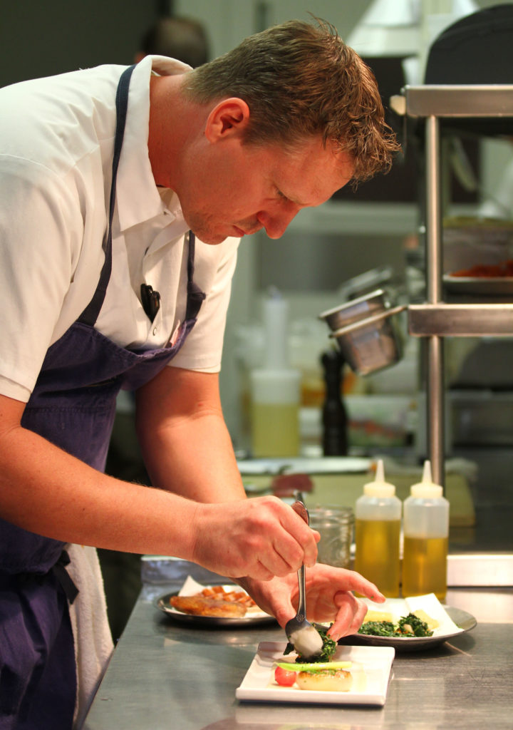 Chef Ryan Fancher of Barndiva plates a duck dish.