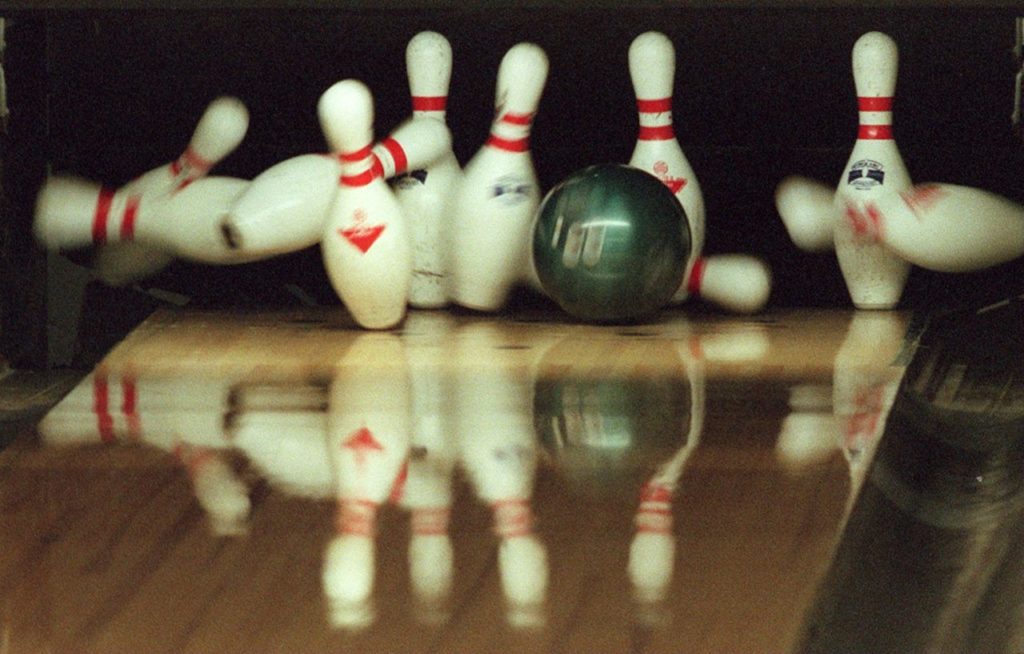 Bowling pins fall as Lois Hartig's ball scores a strike at Windsor Bowl in Windsor.