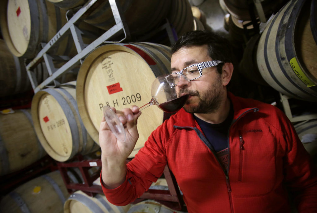 Hardy Wallace with Dirty and Rowdy Family Wines tastes a sample from one his barrels at Punchdown Cellars in Santa Rosa on Tuesday, July 15, 2014. (Conner Jay/The Press Democrat)