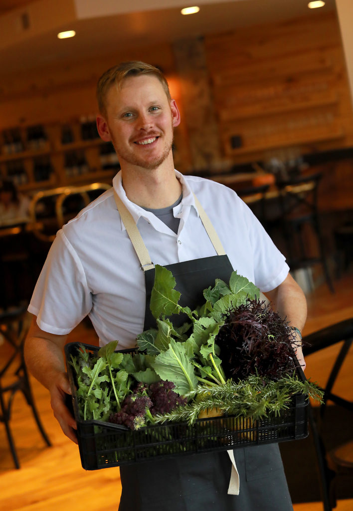Trading Post Market & Bakery chef and owner Eric Johnson proudly shows off produce from the Trading Post garden in Cloverdale. (John Burgess/The Press Democrat)