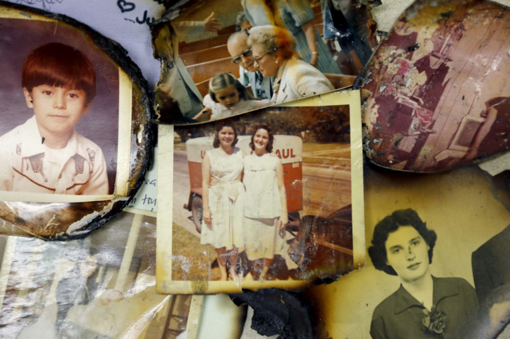 Photographs and papers damaged by the recent fires have been found and sent to Donald Laird, Chair of Computer Studies Dept., and his son, Sutter, who are collecting them and working to reunite them with their owners. Photo taken in his classroom at the Santa Rosa Junior College in Santa Rosa, on Sunday, October 29, 2017. (BETH SCHLANKER/ The Press Democrat)