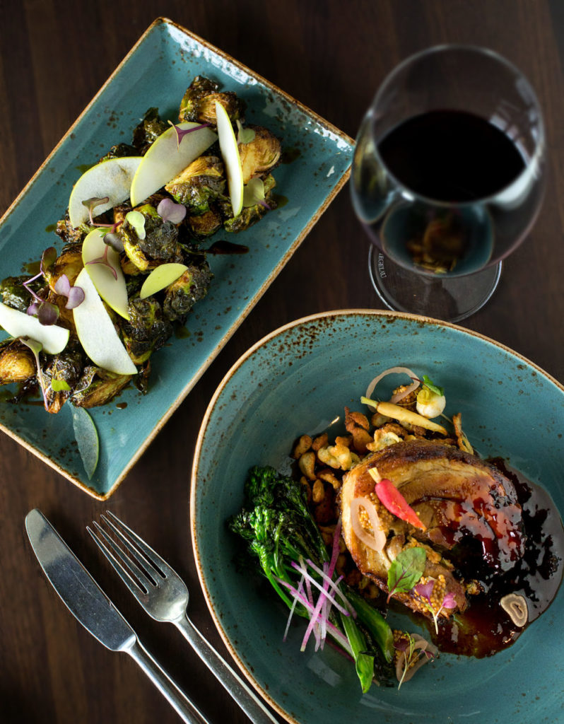 Lichen, lower right, with wood roasted Niman ranch pork belly, black pepper spaetzli, broccolini and a hoisin glaze with a side of Crispy Fried Brussels Sprouts with apples and honey soy vinaigrette from the Carneros Bistro & Wine Bar in Sonoma. (photo by John Burgess/The Press Democrat)