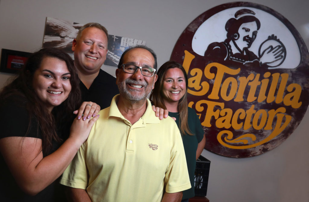 Five generations of the Tomayo family have been involved with the running of La Tortilla Factory in Santa Rosa. From left, Jenny Tomayo is a high school student learning the business this summer, Sam Tomayo, CEO, Willie Tomayo, VP and marketing specialist Jenny Tomayo. (John Burgess/The Press Democrat)