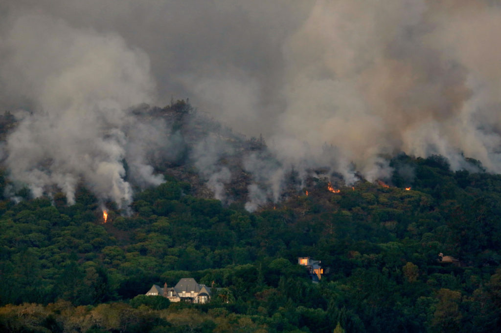 Flames from the Southern Complex fire creep downhill toward homes overlooking Kenwood Vineyards, in Kenwood, California, on Tuesday, October 10, 2017. (Photo by Alvin Jornada)
