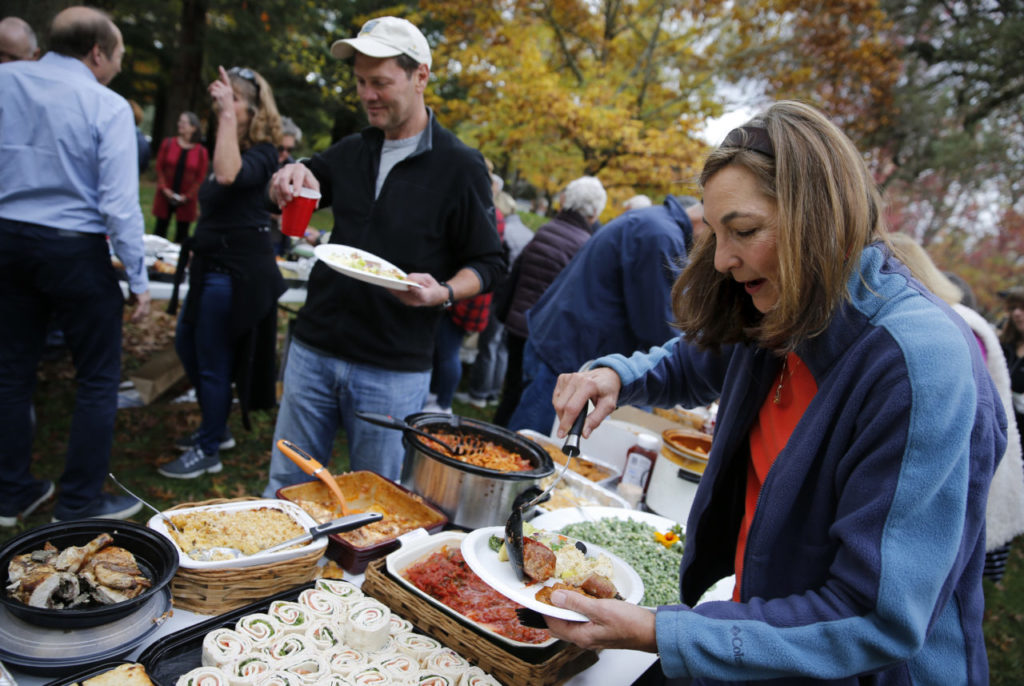 Lynn Koch serves herself some food during a community potluck to thank the Kenwood firefighters at Plaza Park in Kenwood, on Sunday, November 12, 2017. (Photo by Beth Schlanker) 