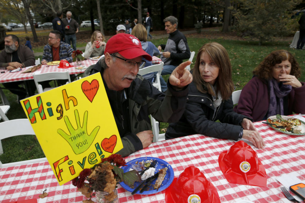 Doug Chance and his girlfriend Lynn Recchia attend a community potluck to thank the Kenwood firefighters at Plaza Park in Kenwood, on Sunday, November 12, 2017. (Photo by Beth Schlanker) 
